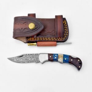 A Damascus folding knife with a multi-colored handle next to a dark brown leather sheath with a ferro rod