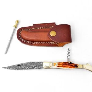 A folding knife with a Damascus blade and corkscrew, a brown leather sheath, and a sharpening steel on a white background
