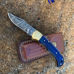 Damascus knife with blue handle, brass bolsters, and leather sheath, with Titan International Knives logo
