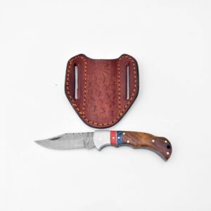 A folding knife with a Damascus blade and a wood handle with colorful stripes is below a brown leather sheath embossed with 'Titeu