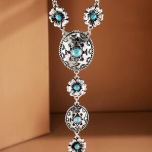 A long silver-toned necklace with turquoise stones set in ornate round, oval, and flower-shaped links