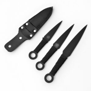 Three black 'Titan Targets' throwing knives with cord-wrapped handles and ring pommels, beside a matching black sheath on a white surface