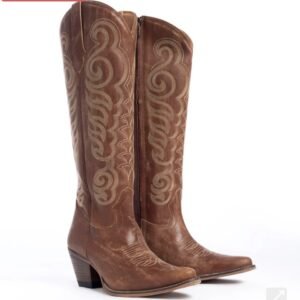 A pair of tall brown distressed cowboy boots with tan embroidered scrollwork and side zippers
