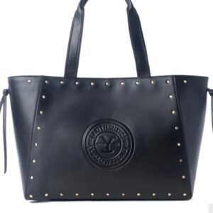 A black tote bag with gold studs along the top and sides, featuring an embossed Yellowstone logo