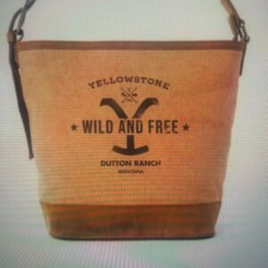 A tan canvas tote bag with brown accents, featuring 'Yellowstone Wild and Free Dutton Ranch Montana' in black text