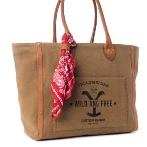 A brown canvas tote bag with leather handles, a red paisley bandana, and "Yellowstone Wild and Free Dutton Ranch Montana" text
