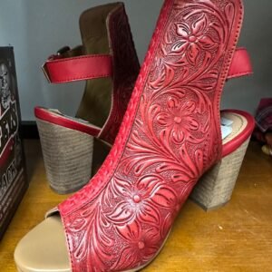 A pair of red floral embossed leather open-toe heels with stacked wooden heels